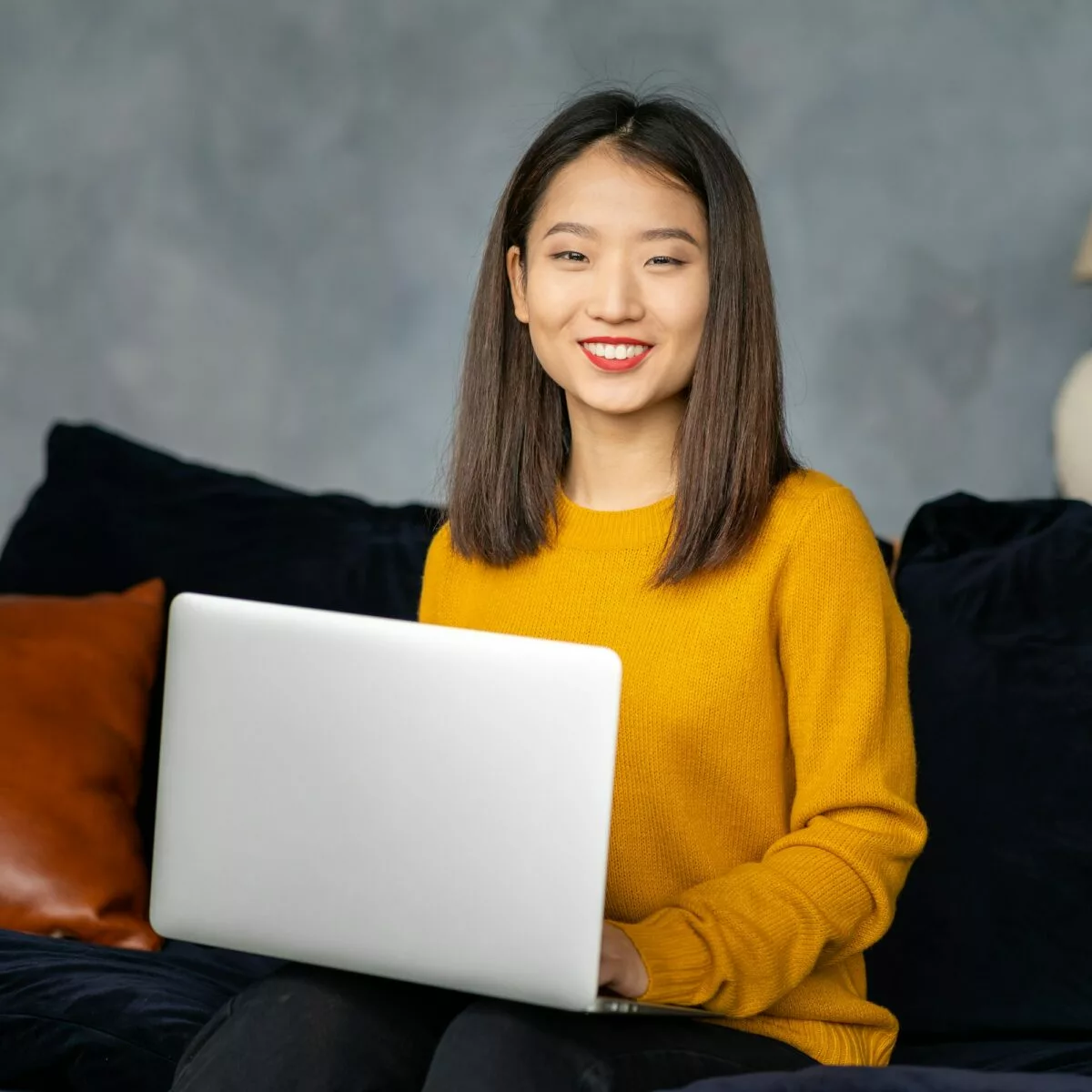 Asian business woman working in laptop on sofa japanese businesswoman work at home.jpg