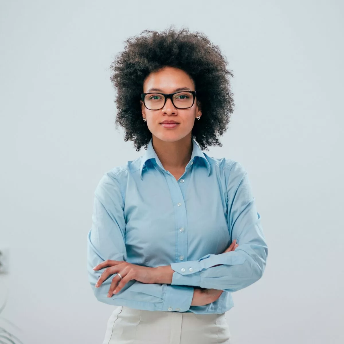 Portrait of a confident businesswoman with curly hair on isolated background .jpg